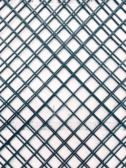 a black and white photo of a metal grid