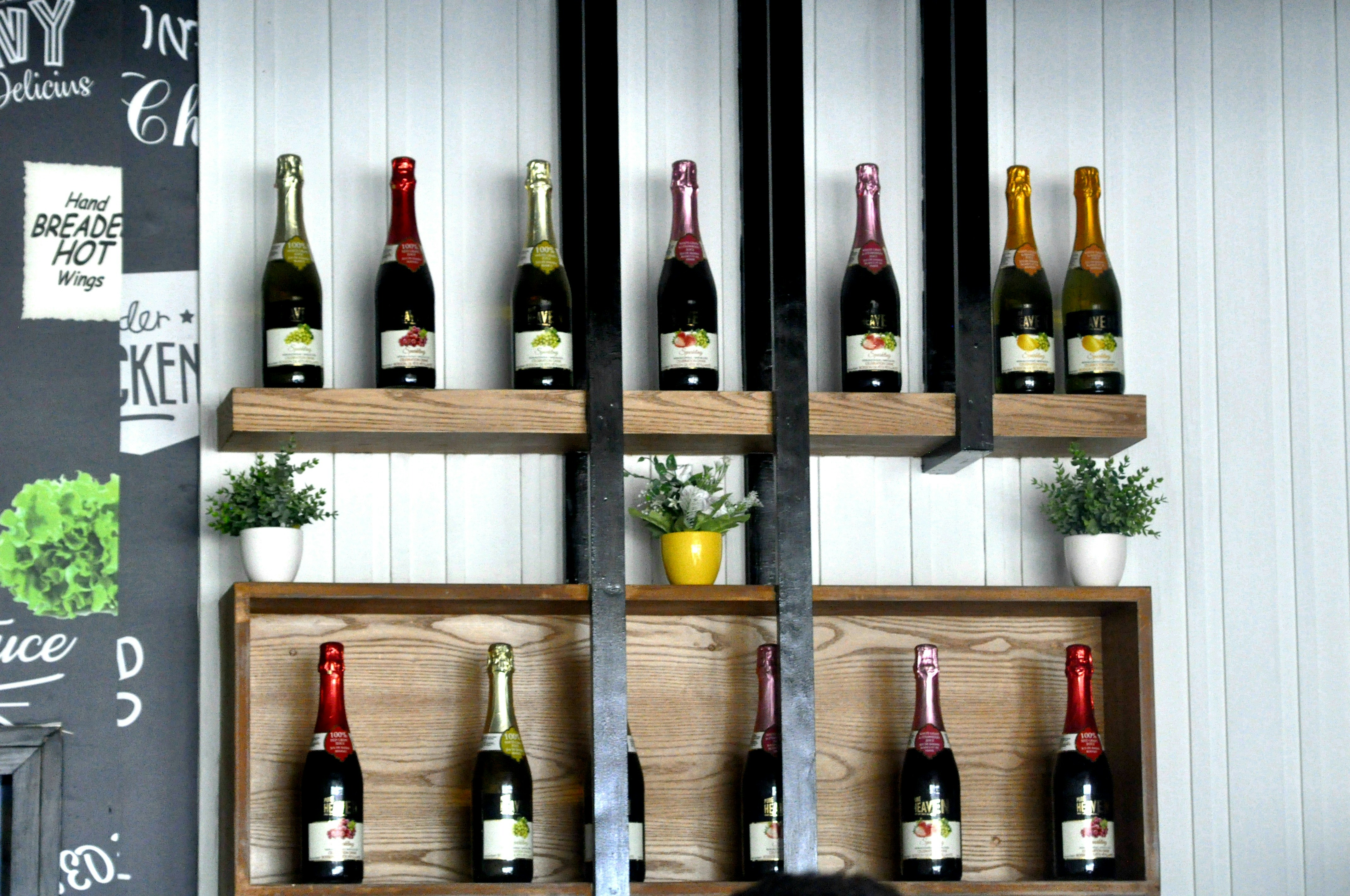 a bunch of wine bottles that are on a shelf