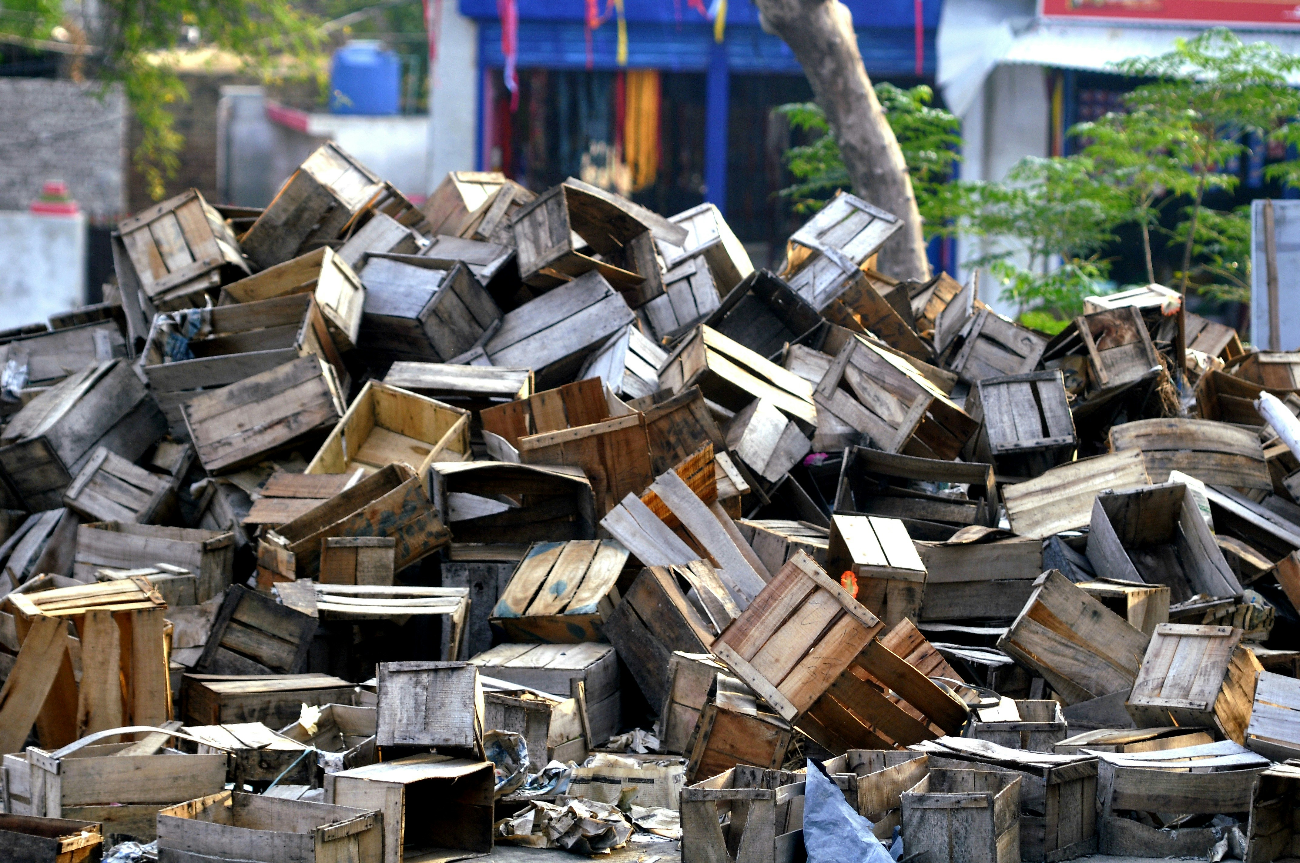 a pile of wooden crates sitting in front of a building