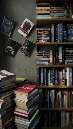 A cozy reading nook with a stack of romance novels featuring glamorous rock stars and elegant royals on the covers.