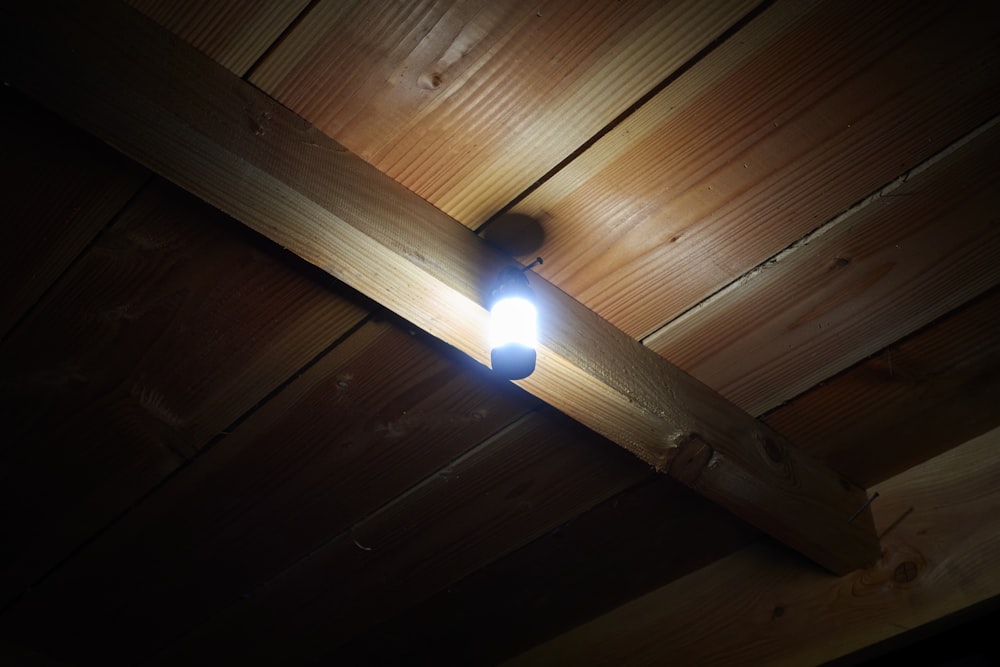 a light that is on a wooden ceiling