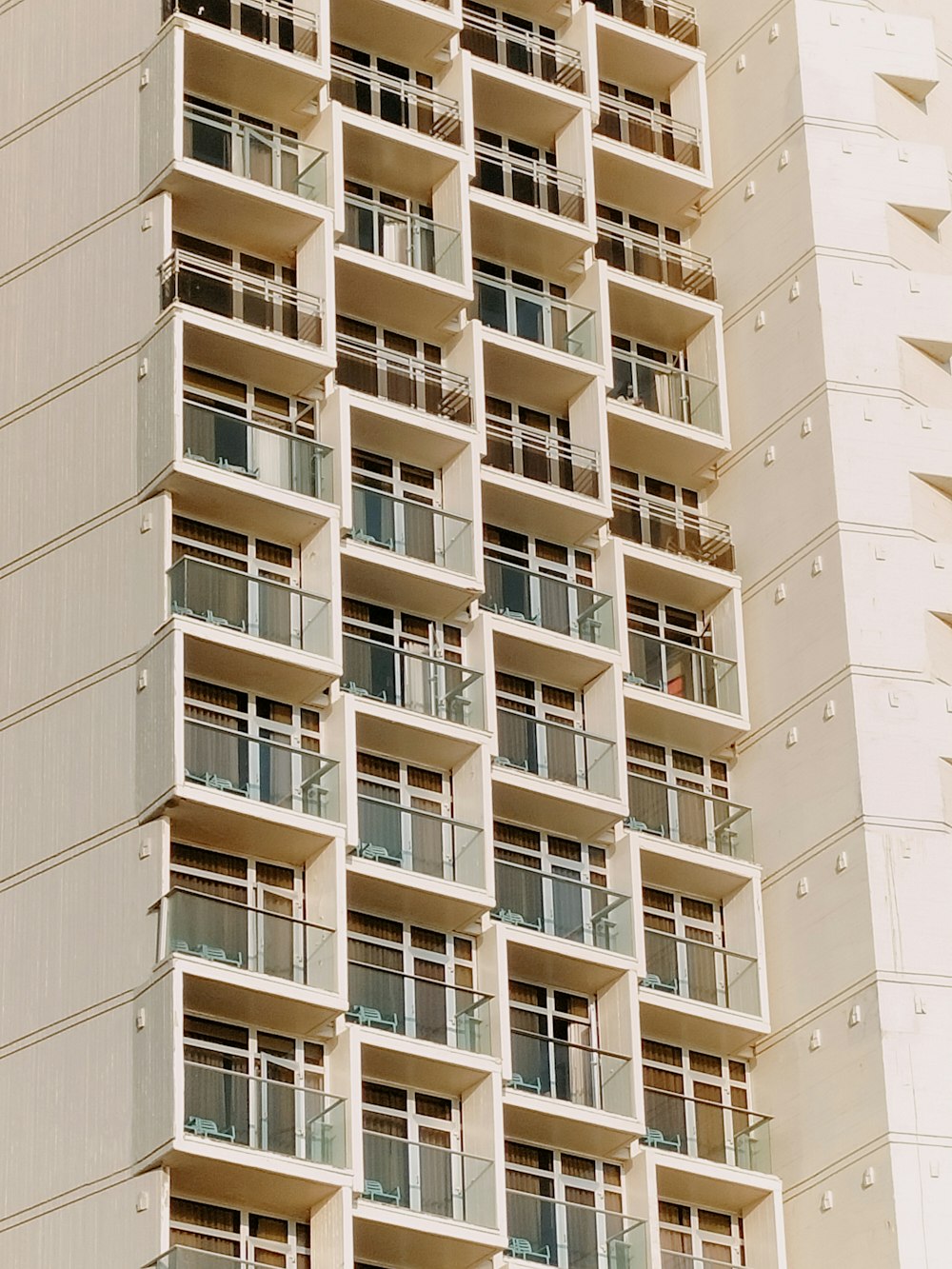 a tall white building with balconies and balconies on the balcon