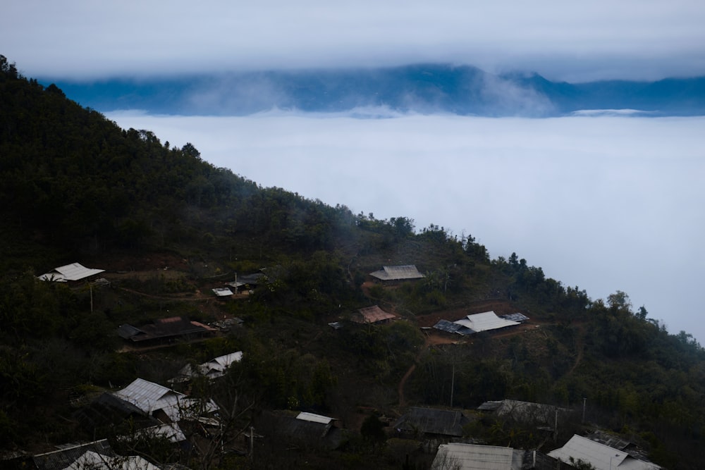a small village on top of a hill surrounded by fog