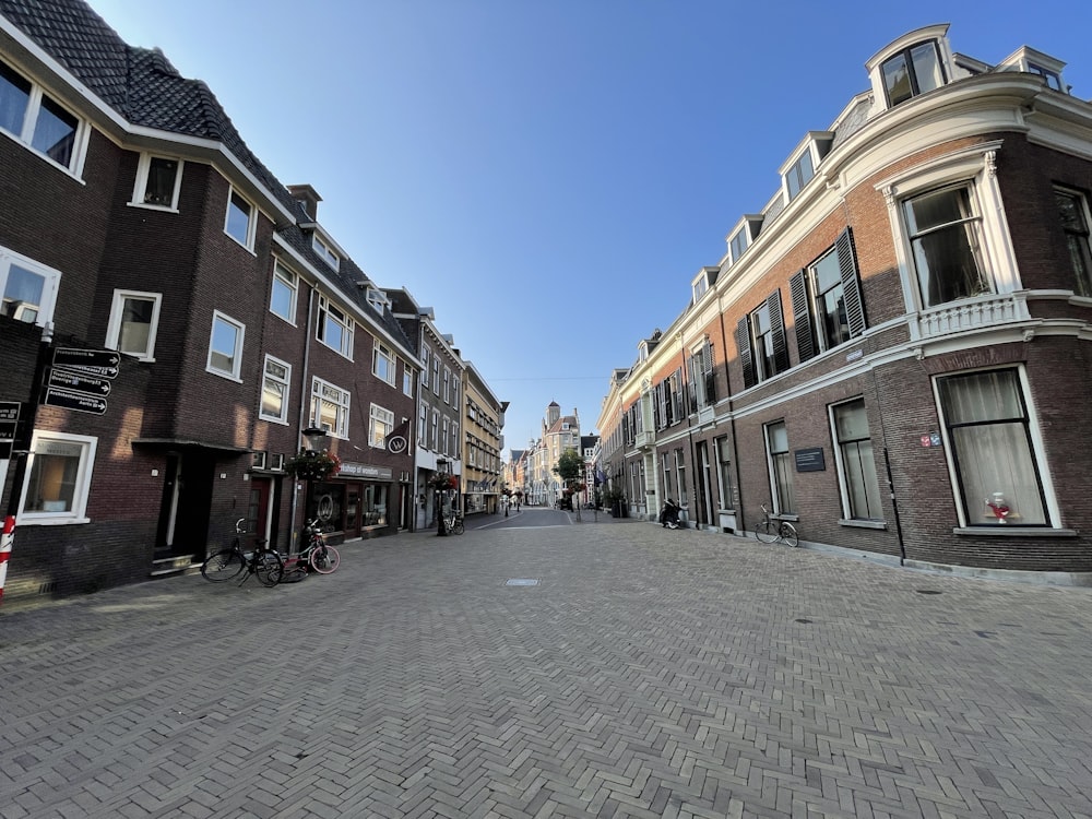 a cobblestone street lined with brick buildings