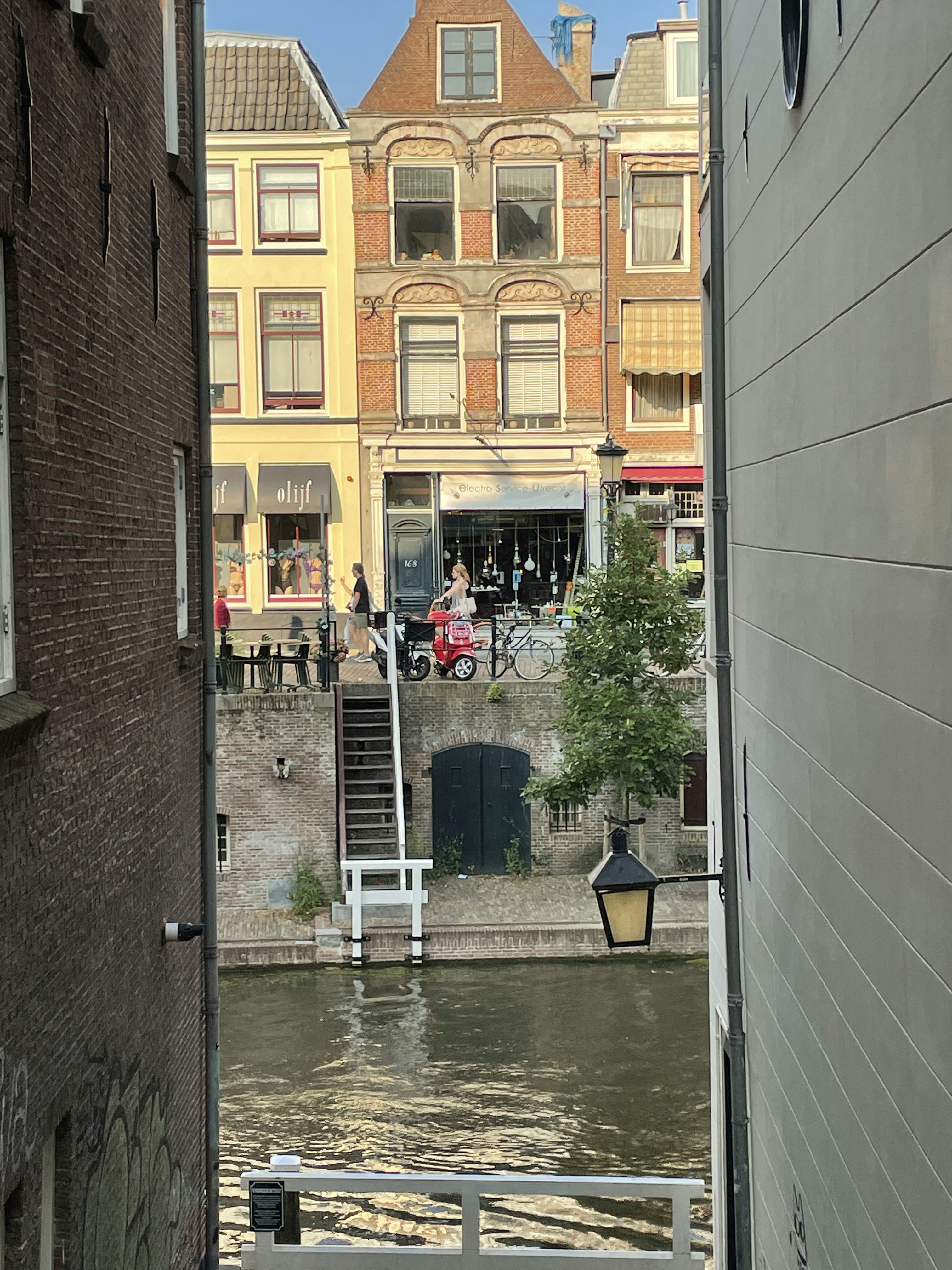 a view of a canal from a narrow alleyway