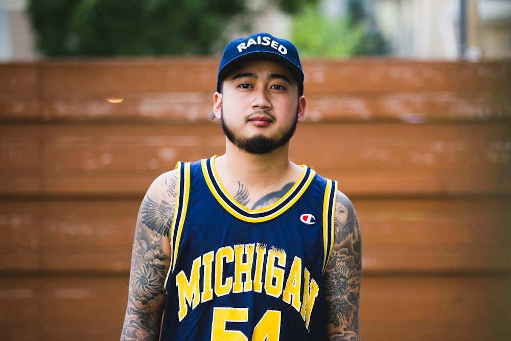 a man in a blue and yellow basketball uniform