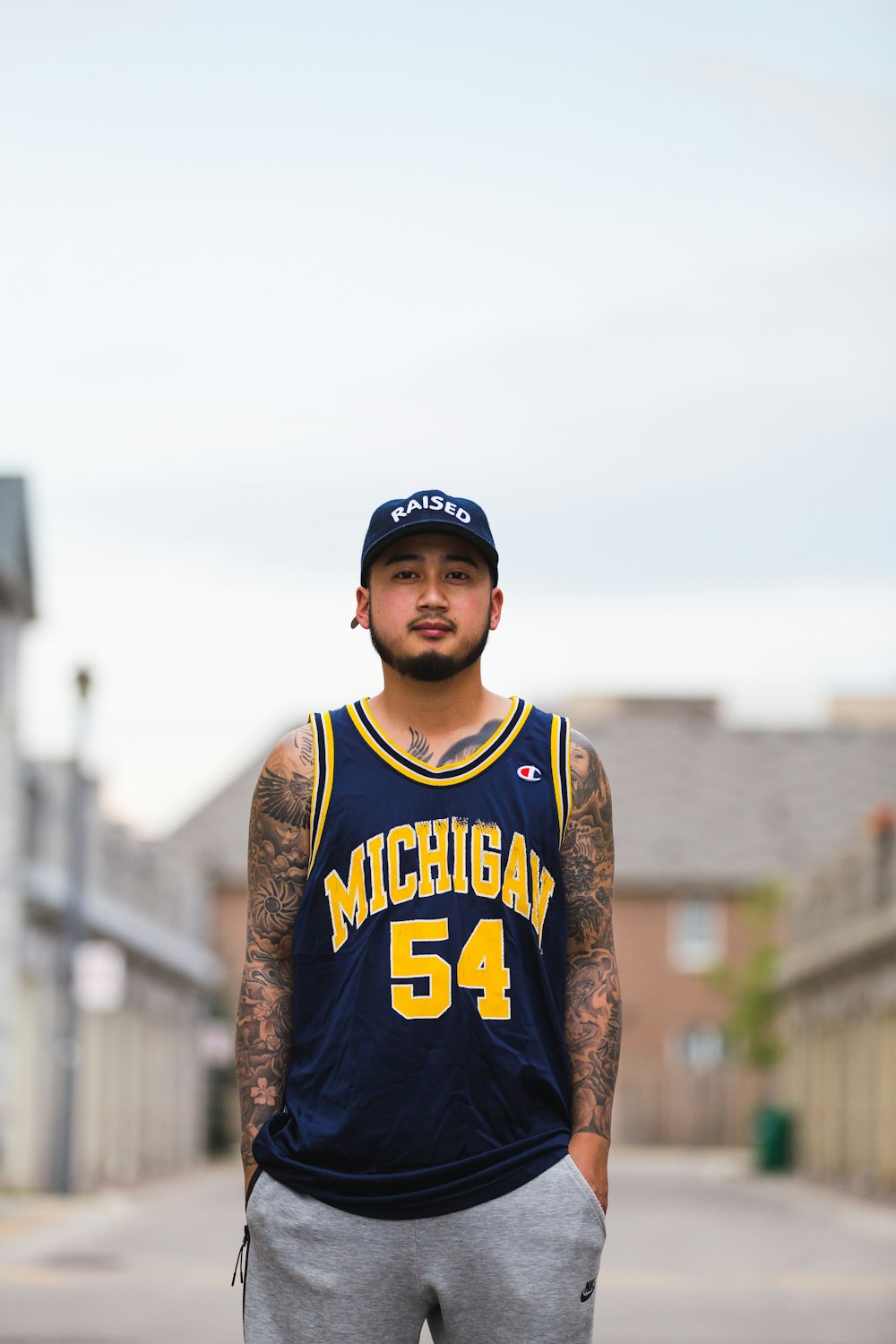 a man in a basketball uniform standing on a street