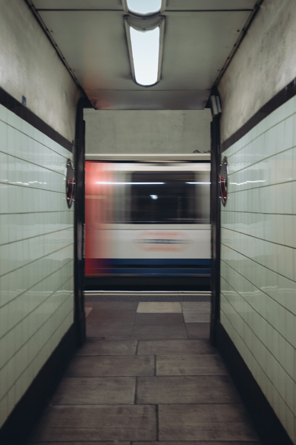 a subway train passing through a subway station