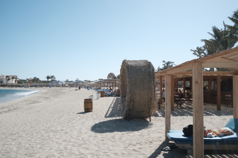 a sandy beach with a few chairs and umbrellas