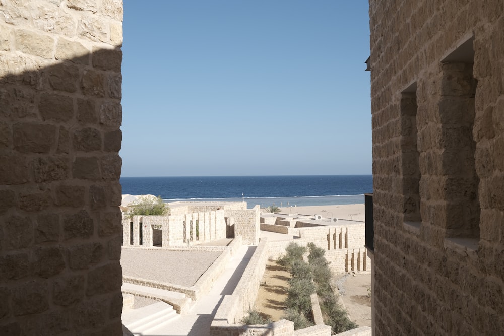 a view of the ocean from a stone building