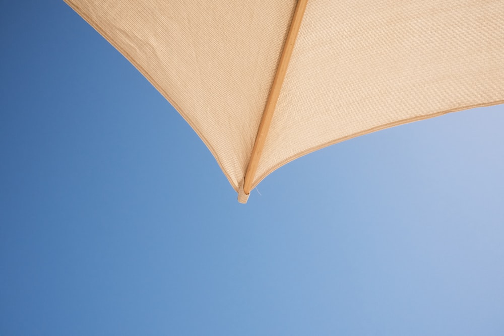 a close up of an umbrella against a blue sky