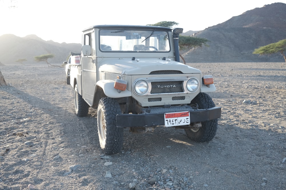 a jeep is parked in the middle of the desert