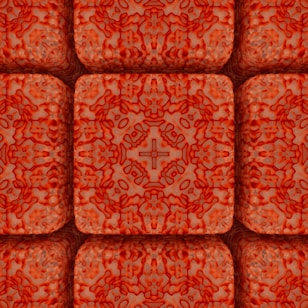 An intricate pattern featuring a series of symmetrical, textured blocks with a dominant red and orange color scheme. Each block appears to have a raised, quilted texture and is arranged in a grid-like formation. The design has a repeating cross motif at the center of each block, surrounded by a web of irregular, abstract shapes reminiscent of organic or biological structures.