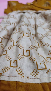 Close-up of a digital dress pattern with fabric swatches nearby.