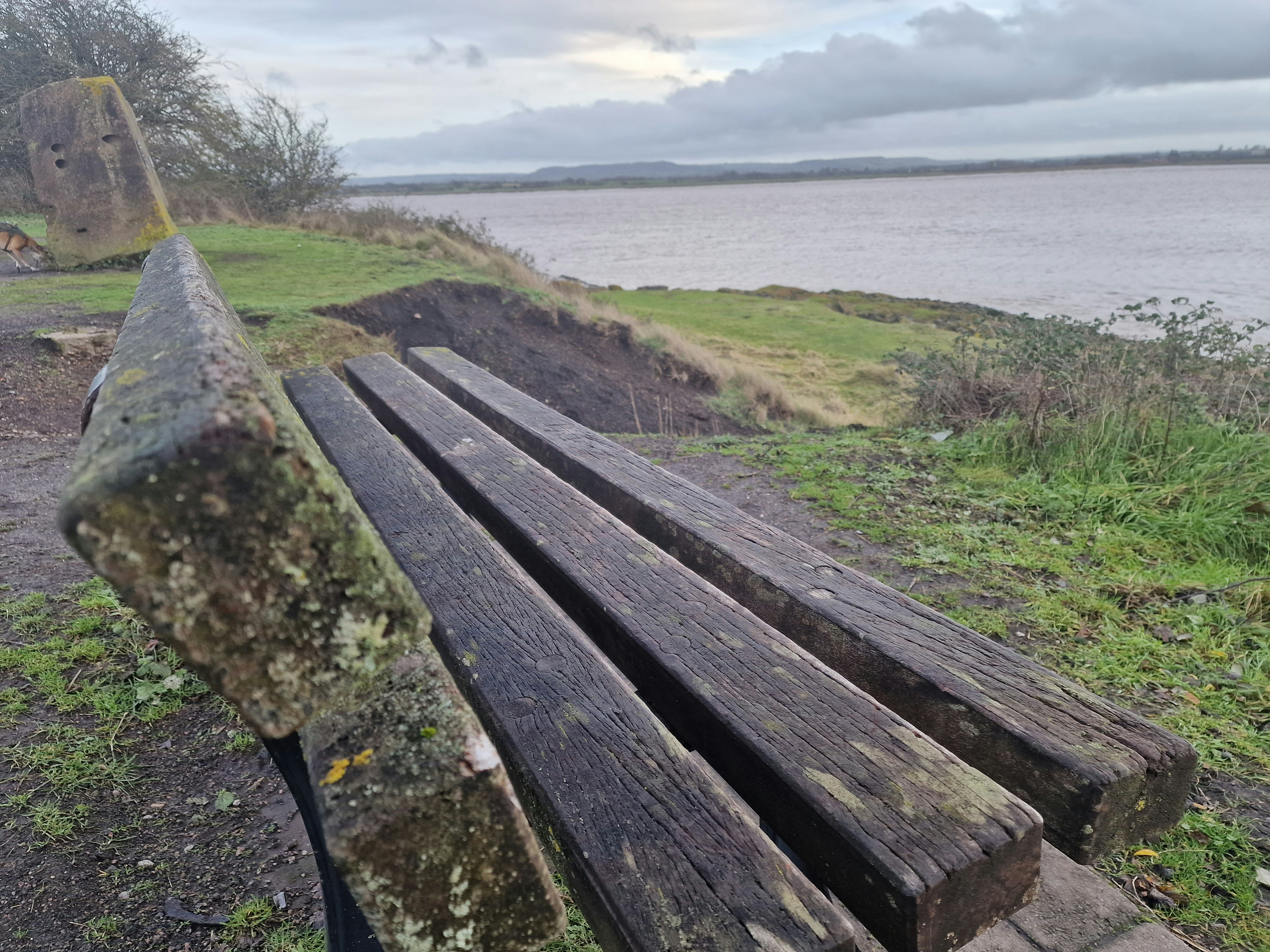 A wooden bench sitting next to a body of water photo – Free Lydney ...