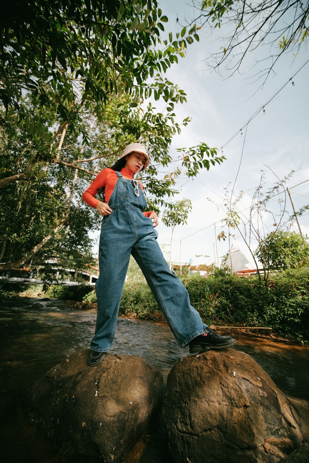 a woman standing on top of a large rock