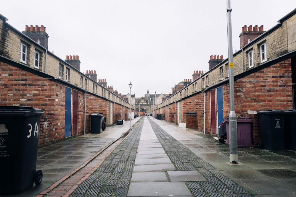 a narrow street with brick buildings on both sides