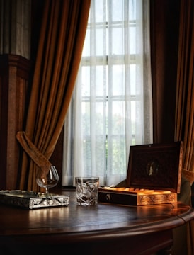 Golden ritual tools arranged on a light wooden table with soft natural lighting