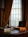 A cozy, softly lit room with a neatly arranged adult toy and silk stocking on a wooden table.