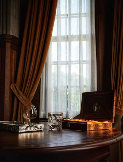 A softly lit marble tray with delicate gold accents resting on a cream linen cloth.