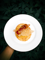 A beautifully plated dessert with a drizzle of honey and a sprinkle of nuts, capturing the care in every bite.