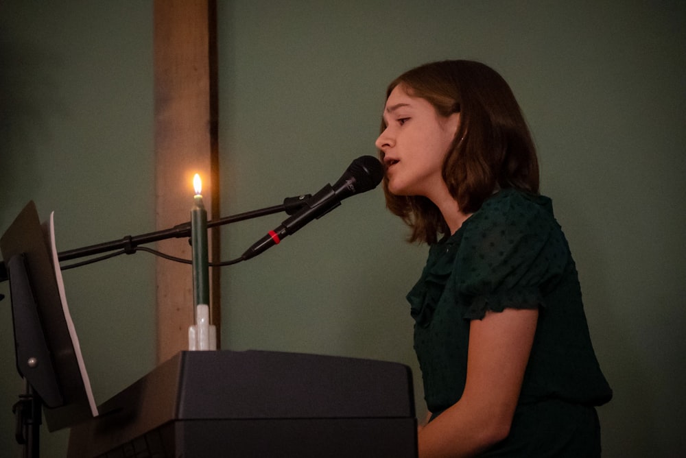 a woman standing in front of a microphone