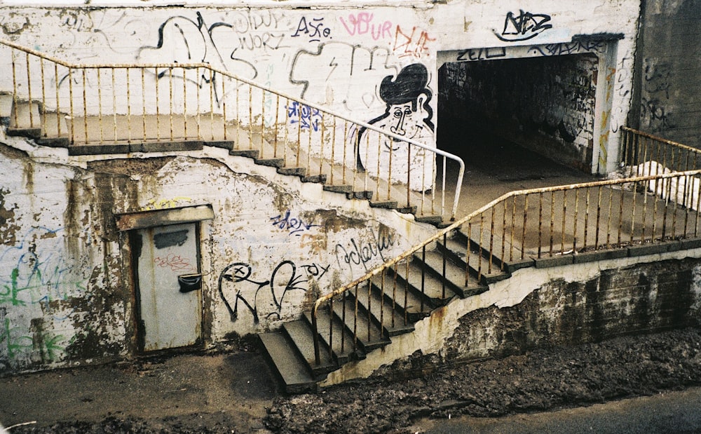 a set of stairs with graffiti on the wall