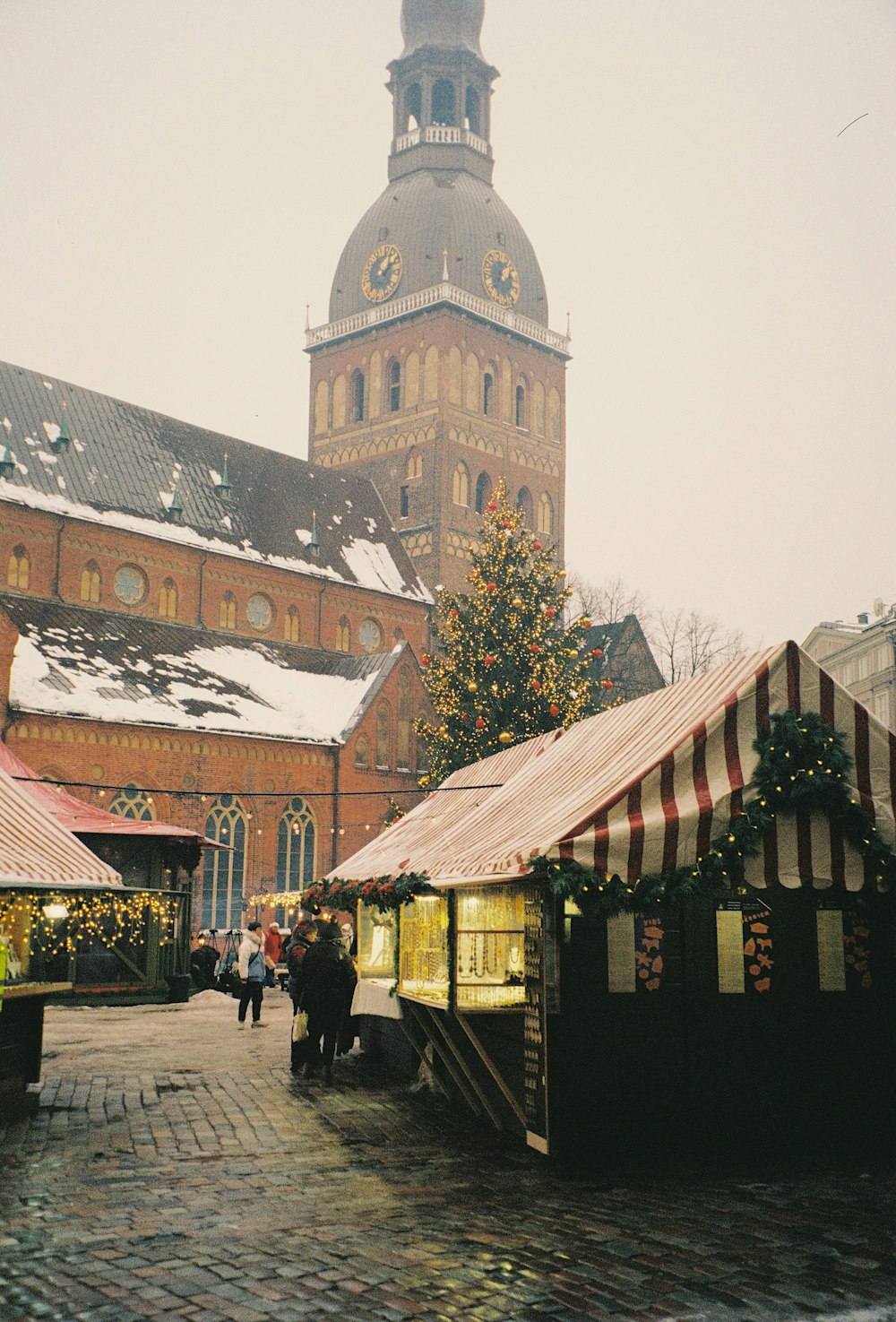 a group of people standing around a christmas market