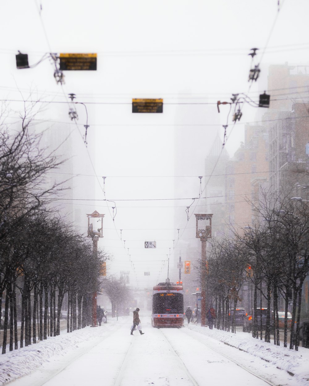 a person walking down a snow covered street