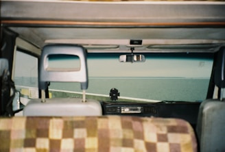 Interior shot of a car with leather seats and a view of the ocean through the window.