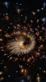 Close-up of golden sparks cascading down like a shimmering waterfall from a custom pyrotechnic display.