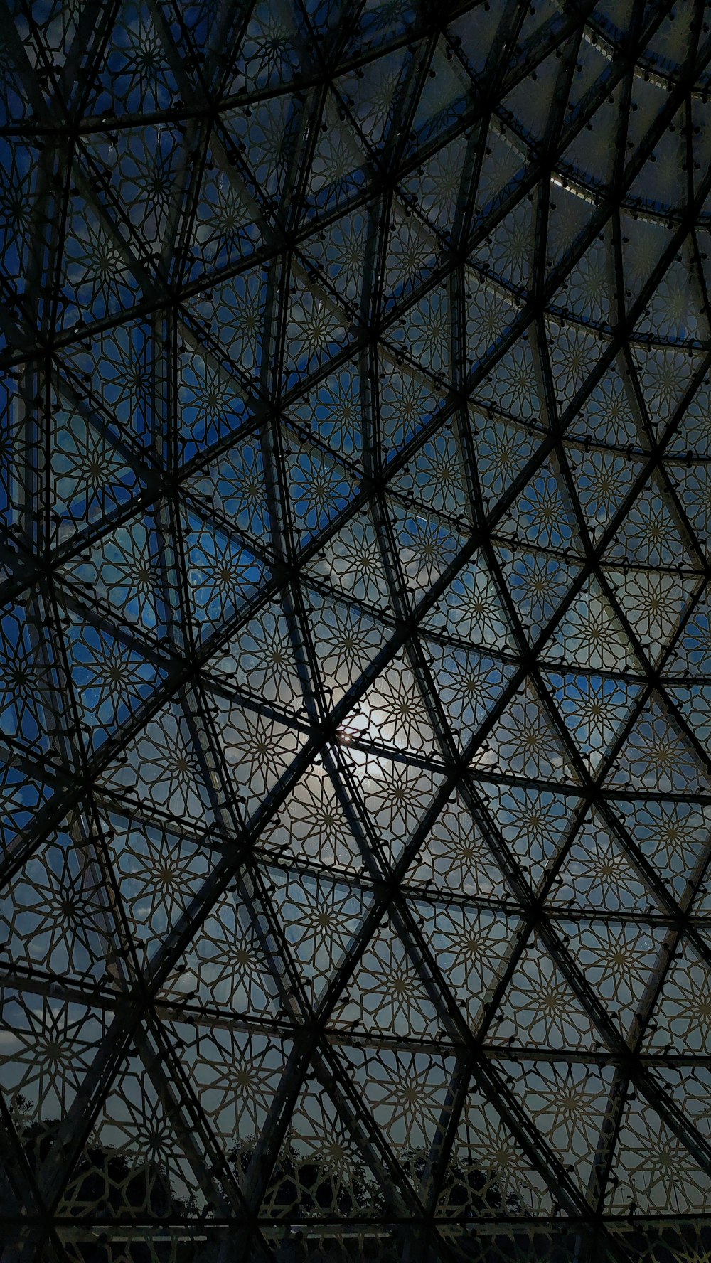 the ceiling of a building with a clock on it