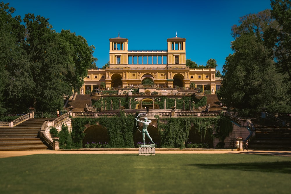 a large building with a statue in front of it