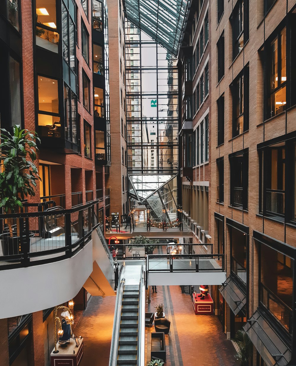 an indoor shopping mall with escalators and stairs