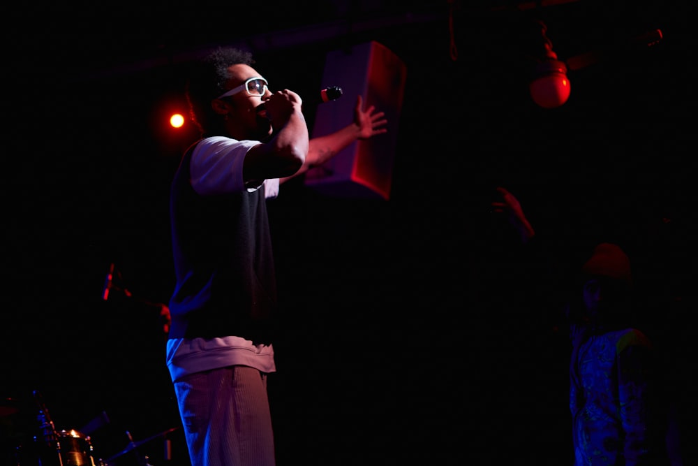 a man standing on a stage holding a microphone