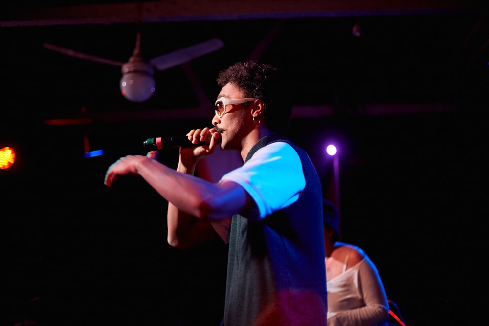 a man standing on a stage holding a microphone