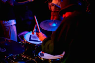 Close-up of a drumline player focused intensely, drumsticks poised to strike.