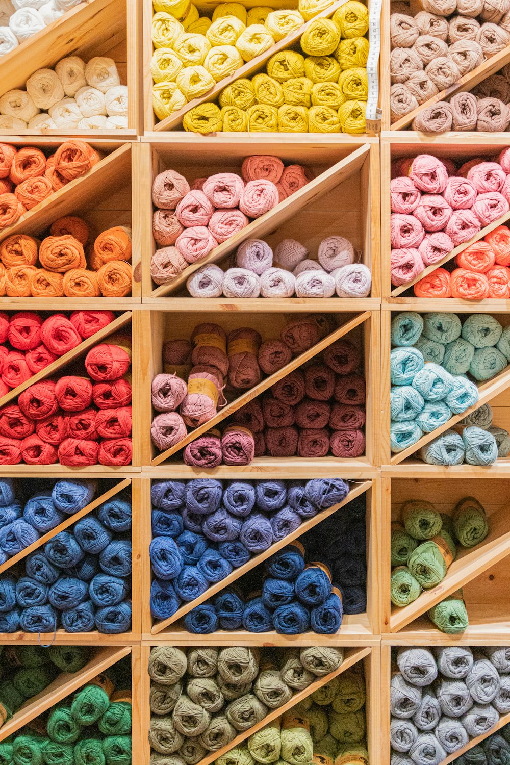 a display case filled with lots of different colored yarn