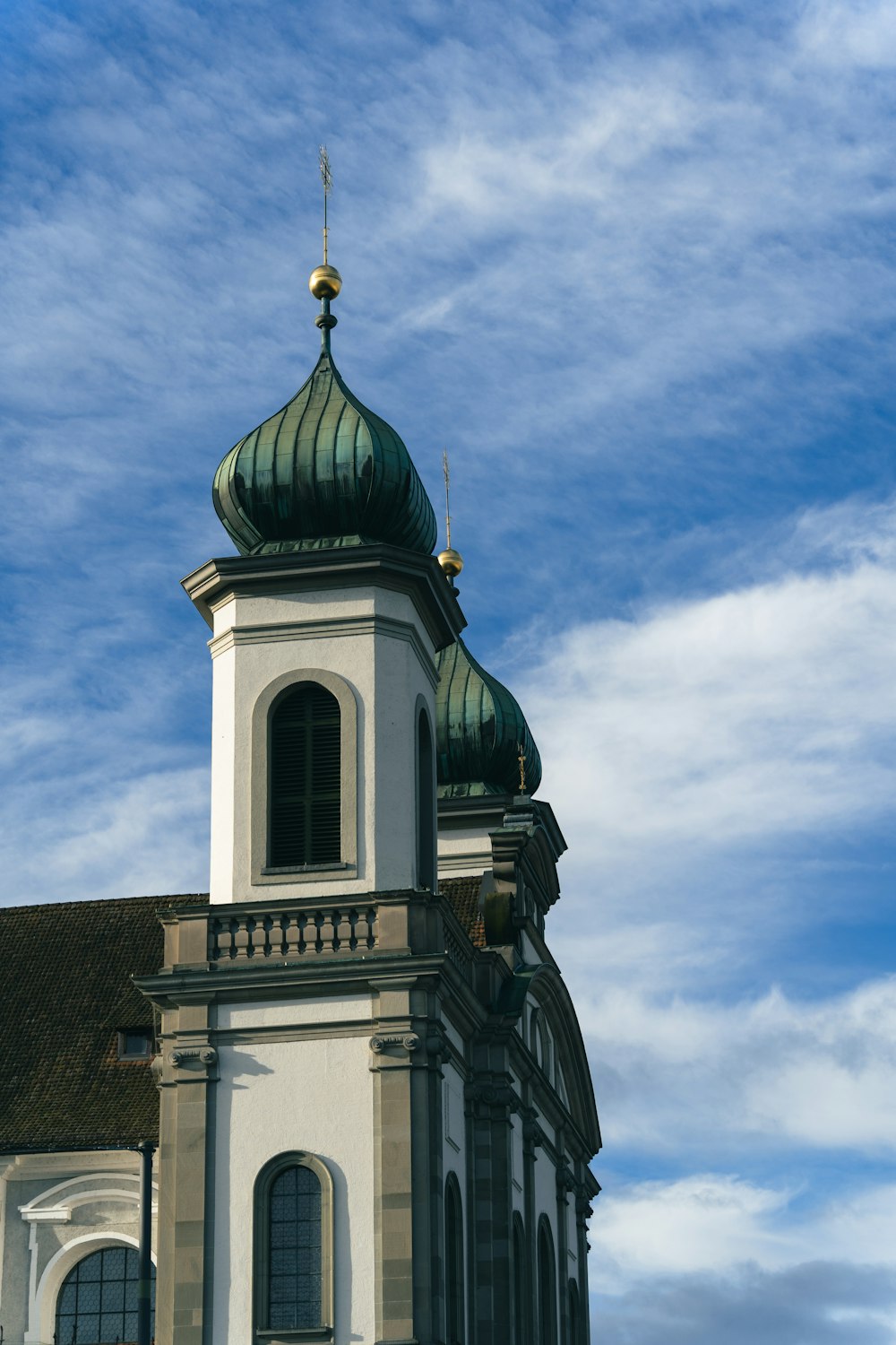 a large white building with a green dome