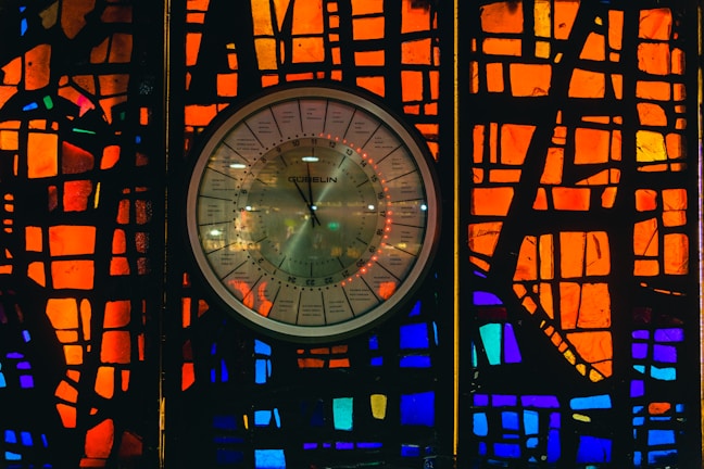 Close-up of a vibrant epoxy wall clock with swirling blue and gold resin patterns.