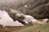 Industrial facility with green technology installations surrounded by trees.