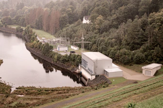 Advanced environmental spill treatment facility with green surroundings under clear skies
