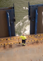 Marine engineers inspecting a tanker’s deck with safety gear on during a routine survey.