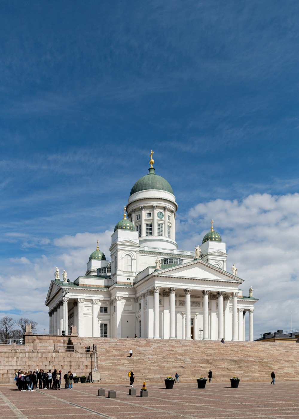 a large white building with a green dome