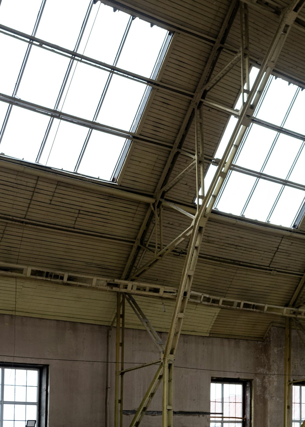 a clock in a building with a skylight above it