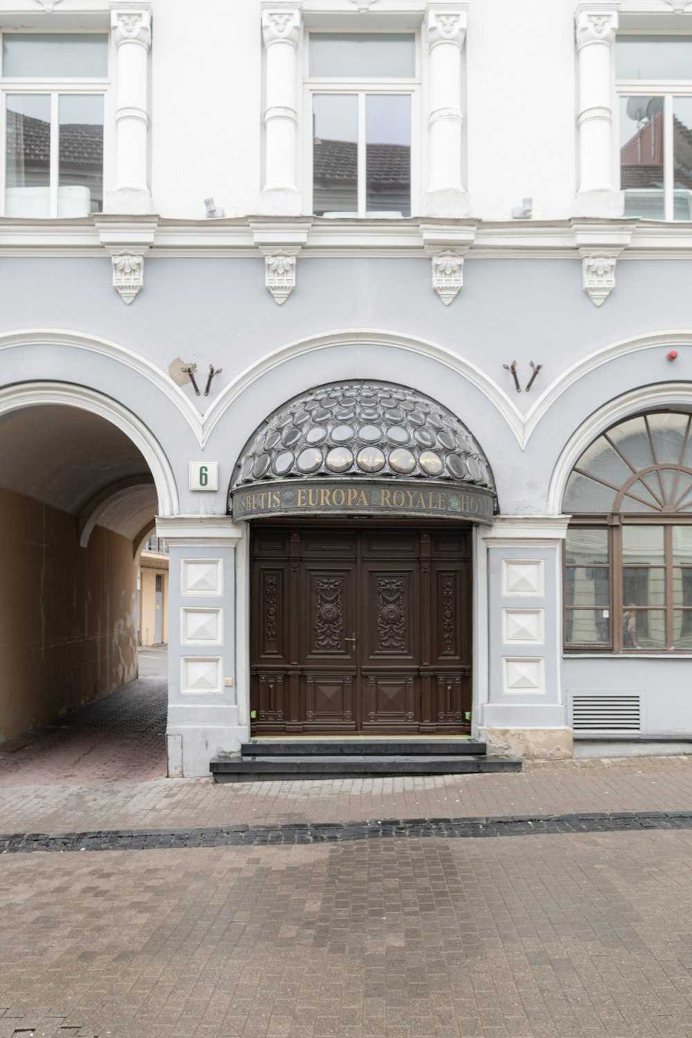 a large white building with a brown door