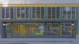 Wide-angle view of the building exterior showing a welcoming entrance with name signage.