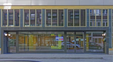 Wide-angle view of the building exterior showing a welcoming entrance with name signage.