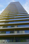 A panoramic shot of a high-rise building with multiple balconies using glass balcony systems