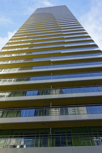 A panoramic view of a high-rise building with balconies overlooking the city.